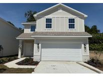 Charming two-story home featuring a two-car garage, tidy landscaping, and a modern architectural design at 2218 Nw 23Rd Loop, Ocala, FL 34475