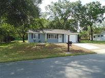Charming single-story home with blue siding, attached garage and well-manicured lawn at 10955 Sw 89Th Ave, Ocala, FL 34481
