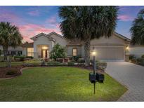 Inviting front yard showcasing lush landscaping and a charming home exterior at 13109 Se 86Th Ct, Summerfield, FL 34491