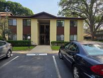 Charming two-story condo building with well-maintained landscaping and ample parking at 501 Fairways Ln # A, Ocala, FL 34472