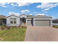 Charming single-Gathering home features a two-car garage and a brick-paved driveway at 5567 Nw 45Th Ln, Ocala, FL 34482
