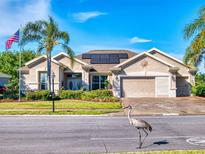 Charming single-story home featuring solar panels, two-car garage, and lush landscaping in a tranquil setting at 9172 Se 130Th Loop, Summerfield, FL 34491