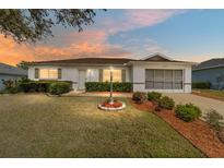 Charming home featuring a well-manicured lawn, tidy landscaping, and an inviting facade at 9741 Sw 97Th Ln, Ocala, FL 34481
