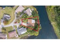 Aerial shot of a waterfront home surrounded by lush greenery and bordered by a tranquil river at 12180 Maple St, Dunnellon, FL 34432