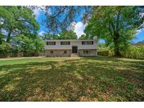 Charming two-story home with brick and stone accents, a well-maintained lawn, and mature trees at 341 Se 53Rd Ct, Ocala, FL 34480