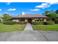 Charming single-story home featuring mature landscaping, a well-manicured lawn, and a welcoming front entrance at 5950 Sw 21St Avenue Rd, Ocala, FL 34471