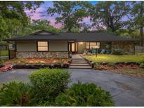 Charming single-story home with stone accents, landscaped garden beds, and a welcoming front porch at 4085 Se 23Rd Ter, Ocala, FL 34480