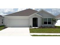 Charming single-story home features a two-car garage and a well-maintained lawn with fresh landscaping at 4731 Sw 88Th Ln, Ocala, FL 34476
