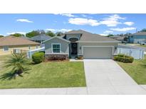 Charming one-story home boasts a well-manicured lawn and inviting two-car garage with neutral paint scheme at 6437 Sw 45Th Ave, Ocala, FL 34474