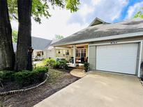 Charming exterior of home with attached garage, landscaping, and covered porch, creating a welcoming curb appeal at 8712 Sw 92Nd Pl # D, Ocala, FL 34481
