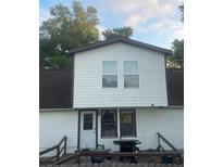 Modest two-story home with wood siding and a grill on the back deck at 14953 Se 107Th Ave, Summerfield, FL 34491