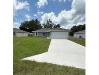 Charming single-story home with a well-maintained lawn and a spacious two-car garage at 13714 Sw 114Th Pl, Dunnellon, FL 34432