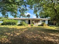 Modest single-story home with mature trees offering shade in the front yard at 2323 Sw 3Rd St, Ocala, FL 34471