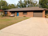 Charming single-story brick home with a well-maintained lawn and a spacious driveway at 4785 Ne 28Th Ter, Ocala, FL 34479