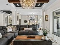 Living room flows into kitchen with a view of kitchen island at 7161 Ne 22Nd Court Rd, Ocala, FL 34479