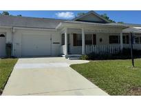 Charming single-story home with a well-maintained front yard and a covered porch at 8680 Sw 94Th St # D, Ocala, FL 34481