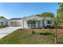 Charming single-story home with a well-manicured lawn and screened two-car garage at 8851 Sw 116Th Street Rd, Ocala, FL 34481