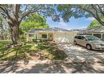 Charming single-story home with a well-manicured lawn, mature trees and an attached two-car garage at 8851 Sw 97Th St # A, Ocala, FL 34481