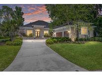 Beautiful single-story home featuring manicured landscaping, a stone facade, and a spacious driveway at 1103 Se 46Th St, Ocala, FL 34480