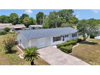 Charming single-story home with a well-manicured lawn, landscaped garden, and a two-car garage at 11118 Sw 76Th Ave, Ocala, FL 34476