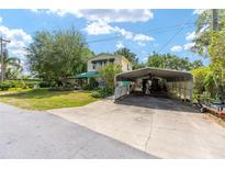 Charming two-story home with a large covered carport and a well-manicured lawn at 31 Se Chinica Dr, Summerfield, FL 34491
