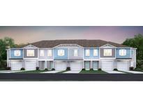 Charming townhome with a two-car garage, front lawn, and tasteful exterior finishes creating curb appeal at 3571 Se 37Th Ct, Ocala, FL 34480