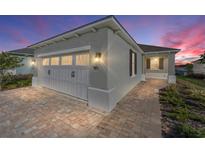 Charming home featuring a two-car garage, brick paver driveway, and well-maintained landscaping at 9697 Sw 102Nd Ter, Ocala, FL 34481