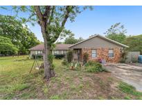 Ranch home with stone facade, mature landscaping, and a charming porch swing for relaxing outdoors at 10575 Sw 27Th Ave, Ocala, FL 34476