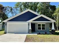 Charming single-Gathering home with a two-car garage and a well-manicured lawn at 13518 Sw 114Th Ln, Dunnellon, FL 34432