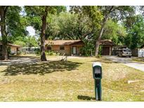 Charming single-story home with a well-maintained front yard and mature trees at 2161 Ne 38Th St, Ocala, FL 34479