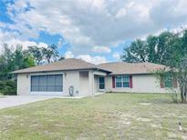 Charming single-story home featuring a well-maintained lawn, screened garage and delightful curb appeal at 2730 Sw 173Rd Place Rd, Ocala, FL 34473