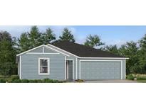 Charming one-story home with light blue siding, white trim, a gray roof, and an attached two-car garage at 4779 Nw 11Th St, Ocala, FL 34482