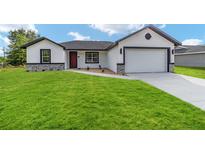 Charming single-story home featuring a well-manicured lawn and a two-car garage at 5 Willow Trl, Ocala, FL 34472