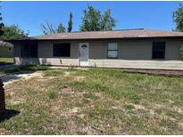 Cozy single-story home with light-colored siding and a well-lit front facade at 5871 Nw 1St St, Ocala, FL 34482