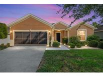 Charming single-story home featuring a well-maintained lawn and a two-car garage at 7432 Sw 98Th Ave, Ocala, FL 34481