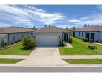 Charming single-story home with a well-manicured lawn and a spacious two-car garage in a residential neighborhood at 9388 Sw 53Rd Pl, Ocala, FL 34481