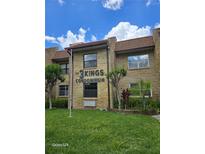 Well-maintained exterior view of a condo building featuring manicured landscaping at 2843 Ne 3Rd St # 109, Ocala, FL 34470