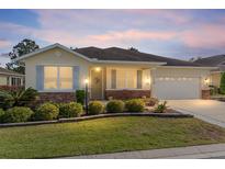 Charming single-story home featuring a well-manicured lawn and neutral color palette exterior at 9728 Sw 95Th Loop, Ocala, FL 34481