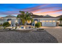 Charming home featuring a well-manicured front yard with palm trees and a paver driveway, plus a two-car garage at 10293 Sw 96Th Ln, Ocala, FL 34481