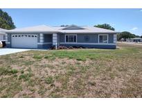 Charming single-story home with a well-manicured lawn and a two car garage, presenting curb appeal at 10315 Sw 62Nd Terrace Rd, Ocala, FL 34476