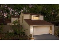 Charming two-story home with an attached garage and well maintained yard at dusk at 113 Weeping Elm Ln, Longwood, FL 32779