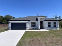 Charming single Gathering home with modern design elements, large garage, and freshly installed landscaping at 455 Marion Oaks Dr, Ocala, FL 34473