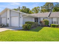 Charming single-story home featuring a well-manicured lawn and attached one car garage in a quiet neighborhood at 10441 Sw 85Th Ct, Ocala, FL 34481