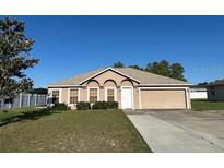 Charming one-story home with a well-maintained lawn and attached two-car garage at 13785 Sw 42Nd Court Rd, Ocala, FL 34473