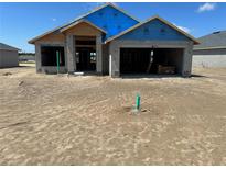 A new construction home with visible concrete walls and a partial roof under a clear blue sky at 3180 Ne 46Th Ave, Ocala, FL 34470