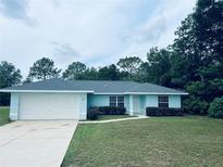 Charming one-story home featuring an attached two-car garage and manicured landscaping at 38 Laurel Ct, Ocala, FL 34480