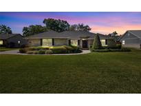 Charming brick home with a beautifully landscaped front yard and walkway leading to the front door at 4424 Se 14Th St, Ocala, FL 34471
