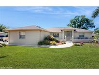 Charming single-story home with well-manicured lawn, garden, and walkway leading to the front door at 4716 Nw 34Th Pl, Ocala, FL 34482