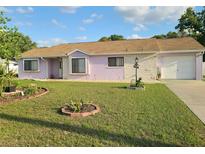 Charming single-story home with a well-maintained lawn and inviting curb appeal under a blue sky at 5606 Sw 107Th St, Ocala, FL 34476