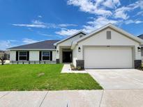 Beautiful single-story home with a well-manicured lawn and a two-car garage at 8482 Sw 59Th Ter, Ocala, FL 34476
